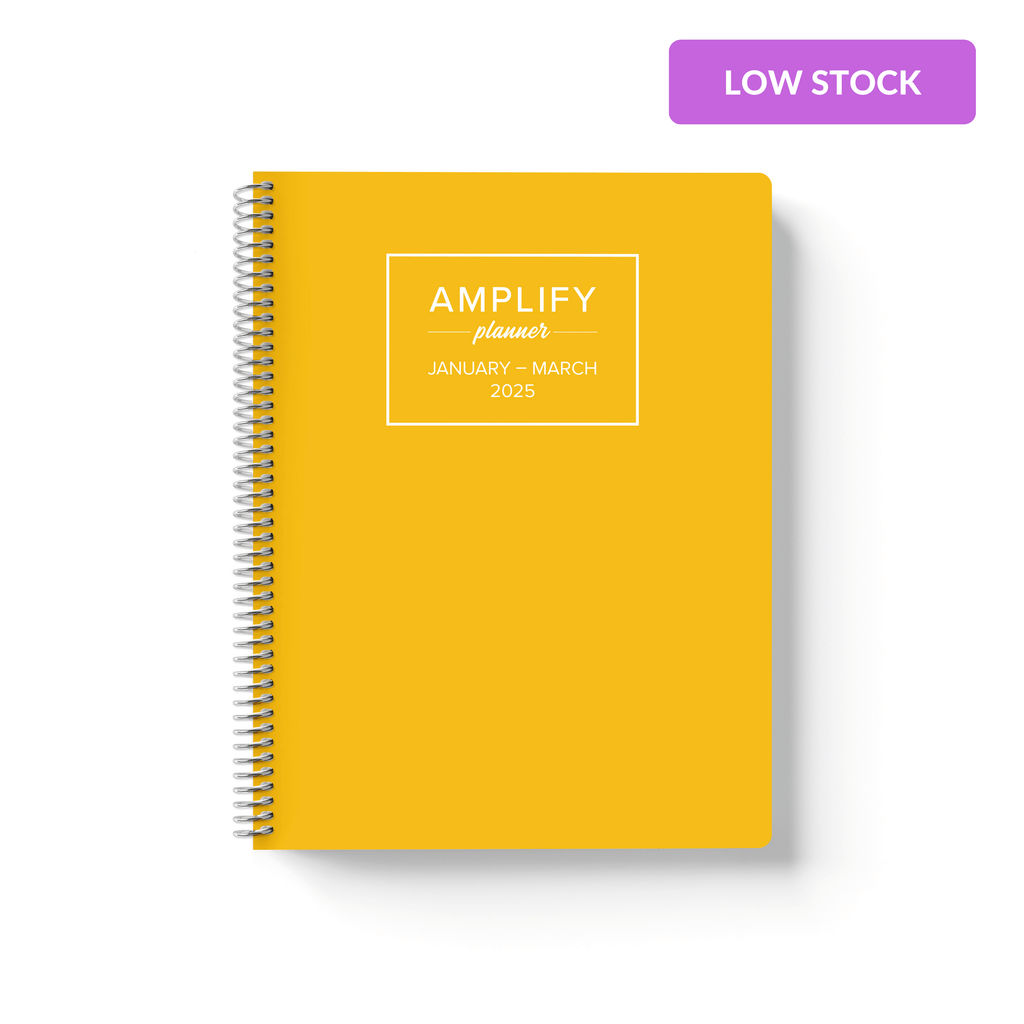 spontaneous yellow cover of Amplify Planner Q1 2025 daily planner on a white background.