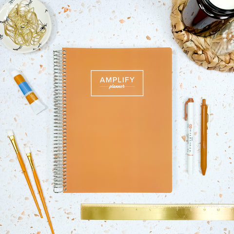 tranquil tan weekly amplify planner on styled background