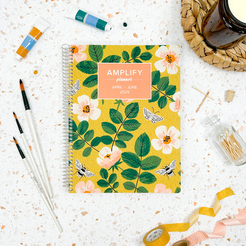 garden whimsy 2025 daily amplify planner on styled background