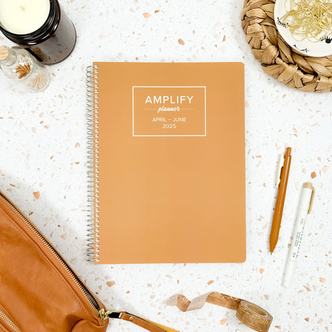 honeycomb 2025 daily amplify planner on styled background